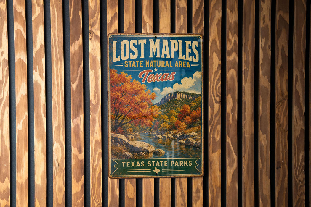 A vintage-style metal sign for Lost Maples State Natural Area in Texas, featuring a scenic landscape with trees and a river.