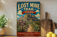 a vintage-style sign for the Lost Mine Trail in Texas, with a mountain landscape and a signpost indicating the trail's name.