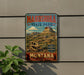 A vintage-style metal sign for Makoshika State Park, featuring a dinosaur skull and a mountain landscape, is displayed on a wall next to a plant.