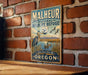 A vintage-style metal sign for the Malheur National Wildlife Refuge in Oregon, featuring a bird and a landscape with mountains in the background.