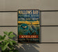 A metal sign on a wall, featuring an illustration of a bird and a body of water, with text indicating it is a sign for the Mallow's Bay-Potomac River National Marine Sanctuary in Maryland.