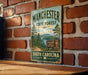A vintage metal sign for Manchester State Forest in South Carolina, featuring a scenic landscape with pine trees and a lake.