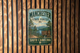 A vintage metal sign for Manchester State Forest in South Carolina, featuring a scenic landscape with pine trees and a lake.