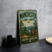 A vintage-style metal sign for the Manchester State Forest in South Carolina, featuring a scenic landscape with pine trees and a lake.