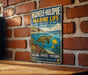 A vintage-style sign for the Manole-Hulopoe Marine Life Conservation District in Hawaii, featuring a turtle and coral reef illustration.