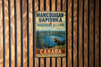 A vintage metal sign for the Manicouagan-Uapishka Biosphere Reserve in Canada, featuring a moose in a forest landscape.