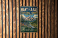 A vintage metal sign for the Manti-La Sal National Forest in Utah, featuring a scenic mountain landscape with a river and pine trees.