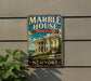 A vintage-style metal sign for the Marble House in Rhode Island, featuring a large image of the White House and the text "A NATION'S TREASURE NEWPORT".