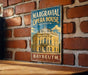 A vintage-style metal sign for the Margravial Opera House in Bayreuth, Germany, featuring an illustration of the opera house and the text "Bayreuth" below it.