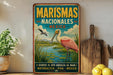 A vintage-style metal sign with a pink flamingo and a river, advertising Marismas Nacionales, Mexico.