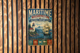 A vintage metal sign for the National Heritage Area in Washington, featuring a lighthouse, a ship, and mountains in the background.