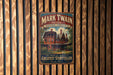 A vintage-style metal sign for Mark Twain House in Hartford, Connecticut, featuring an illustration of a large, ornate house surrounded by trees.