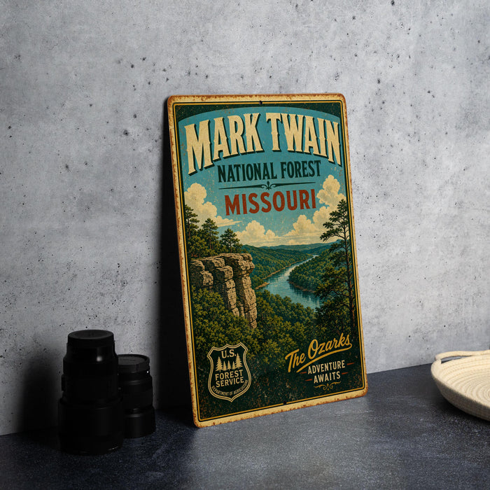A vintage-style metal sign advertising the Mark Twain National Forest in Missouri, featuring a scenic landscape with a river and mountains.