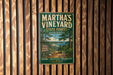 A vintage-style metal sign for Martha's Vineyard State Forest in Massachusetts, featuring a scenic illustration of a forest and a river.