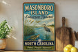 A vintage-style sign for Masonboro Island Estuarine Reserve in North Carolina, featuring a seagull and a turtle in a grassy area with a body of water.