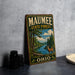 A vintage metal sign for the Maumee State Forest in Ohio, featuring an illustration of a deer in a forest setting.
