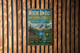 a vintage metal sign with a mountain landscape and text promoting Medicine Bow-Rout National Forests in Colorado and Wyoming.