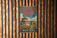 A vintage-style metal sign for Medicine Rocks State Park in Montana, featuring a scenic landscape with rock formations and a cloudy sky.