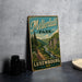 A vintage metal sign for "Müllerdall Park" in Luxembourg, featuring a scenic landscape with a river and mountains.