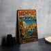 A vintage-style metal sign advertising "Memphis and its Necropolis" and "The Pyramid Fields Giza to Dakhur Egypt" is displayed on a gray wall.