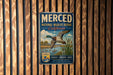 A vintage-style metal sign for the Merced National Wildlife Refuge in California, featuring a duck in flight and a scenic landscape.