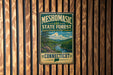 A vintage metal sign for the Mesomorphic State Forest in Connecticut, featuring a scenic landscape with a river and mountains.
