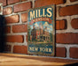 A vintage-style sign for Mills Mansion, a historic landmark in New York, is displayed on a brick wall.