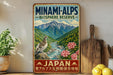 a vintage-style metal sign with a mountain landscape and a bird perched on a rock, along with some flowers and a wooden cutting board.