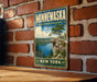 A vintage-style metal sign for Minnewaska State Park Preserve, featuring a scenic landscape with a cliff overlooking a lake and pine trees.