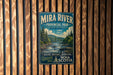 A vintage-style metal sign for Mira River Provincial Park in Nova Scotia, featuring a scenic landscape with a river, mountains, and pine trees.