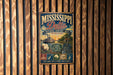 A vintage metal sign for the Mississippi Delta National Heritage Area, featuring illustrations of a river, a steamboat, and a house, along with text promoting the area's history, culture, and heritage.