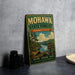A vintage-style metal sign for the Mohawk State Forest in Connecticut, featuring a scenic landscape with pine trees, a river, and mountains.
