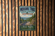 A vintage-style metal sign for the Mohawk Trail in Massachusetts, featuring a scenic mountain landscape and the trail's name.