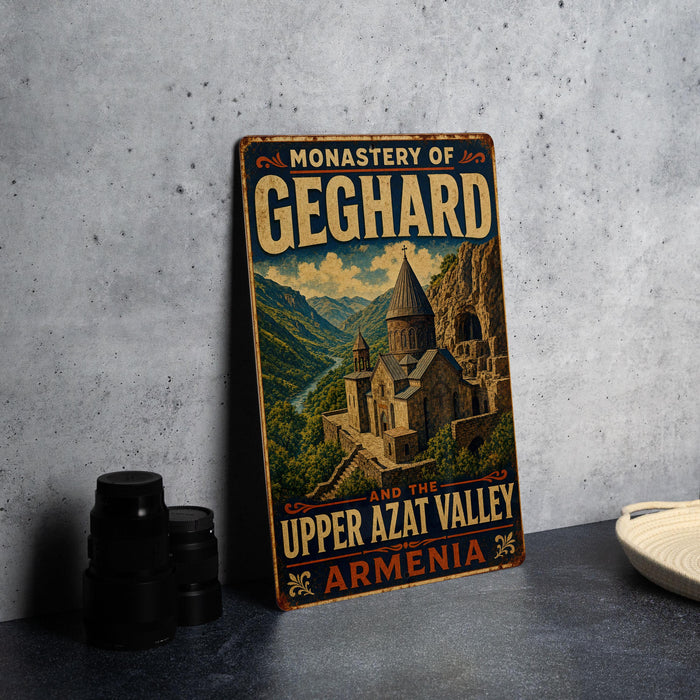 A vintage-style metal sign with the text "MONASTERY OF GEGHARD AND THE UPPER AZAT VALLEY ARMENIA" and an illustration of a castle or cathedral in the background.