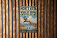 A vintage-style metal sign for the Monte Vista National Wildlife Refuge in Colorado, featuring a bird in flight and a scenic landscape.