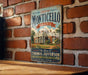 A vintage-style metal sign for the historic Monticello, Virginia, the home of Thomas Jefferson, is displayed on a brick wall.