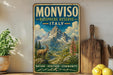 a vintage-style metal sign with a mountain landscape and a goat, placed on a shelf next to a wooden cutting board and some lemons.