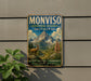 A vintage-style metal sign with a mountain landscape and a goat, mounted on a wall.