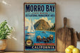 A vintage-style metal sign for Morro Bay State Marine Recreational Management Area, featuring a sailboat, sea lions, and a mountain landscape.
