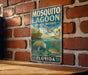 A vintage-style metal sign for Mosquito Lagoon Aquatic Preserve in Florida, featuring illustrations of various marine life such as a manatee, a sea turtle, and a bird.