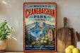 A vintage-style poster advertising Mount Changbai Park in China, featuring a scenic mountain landscape with a lake and pine trees.