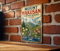 A vintage-style metal sign with the text "Mount Hakusan" and "Biosphere Reserve Japan" is displayed on a brick wall.