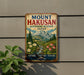 A vintage metal sign with a mountain landscape and flowers, mounted on a wall.
