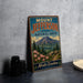 A vintage-style metal sign for Mount Jefferson State Natural Area in North Carolina, featuring a mountain landscape with pine trees and pink flowers.