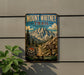 Mount Whitney Trail sign on a wall, featuring a scenic mountain landscape with a trail and a sign indicating the trail's name and distance.