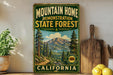 a vintage-style sign for the Mountain Home State Forest in California, with a scenic mountain landscape and pine trees.