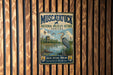 A vintage metal sign for the Muscatuck National Wildlife Refuge in Indiana, featuring an illustration of a bird and a pond surrounded by reeds.