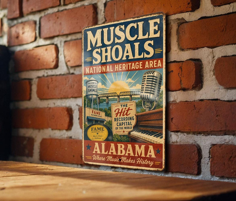 A vintage metal sign on a brick wall advertising the Muscle Shoals National Heritage Area in Alabama.