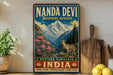 A vintage-style sign for the Nanda Devi Biosphere Reserve in Western Himalaya, India, featuring a mountain landscape with a goat and pink flowers.