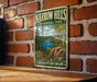 A vintage-style metal sign for Narrow Hills Provincial Park in Saskatchewan, featuring a scenic landscape with a lake and mountains.